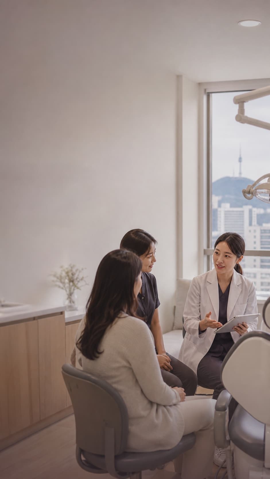 Korean dental specialist, coordinator, and international patient in a private consultation